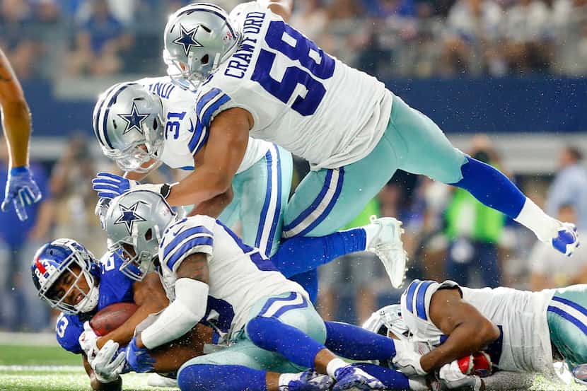 New York Giants running back Rashad Jennings (23) is tackled by Dallas Cowboys middle...