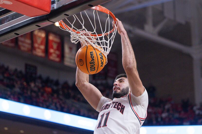 Texas Tech's Fardaws Aimaq (11) dunks the ball during the second half of an NCAA college...
