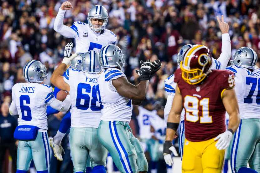 Dallas Cowboys kicker Dan Bailey (5) is lifted up by his teammates after scoring the game...
