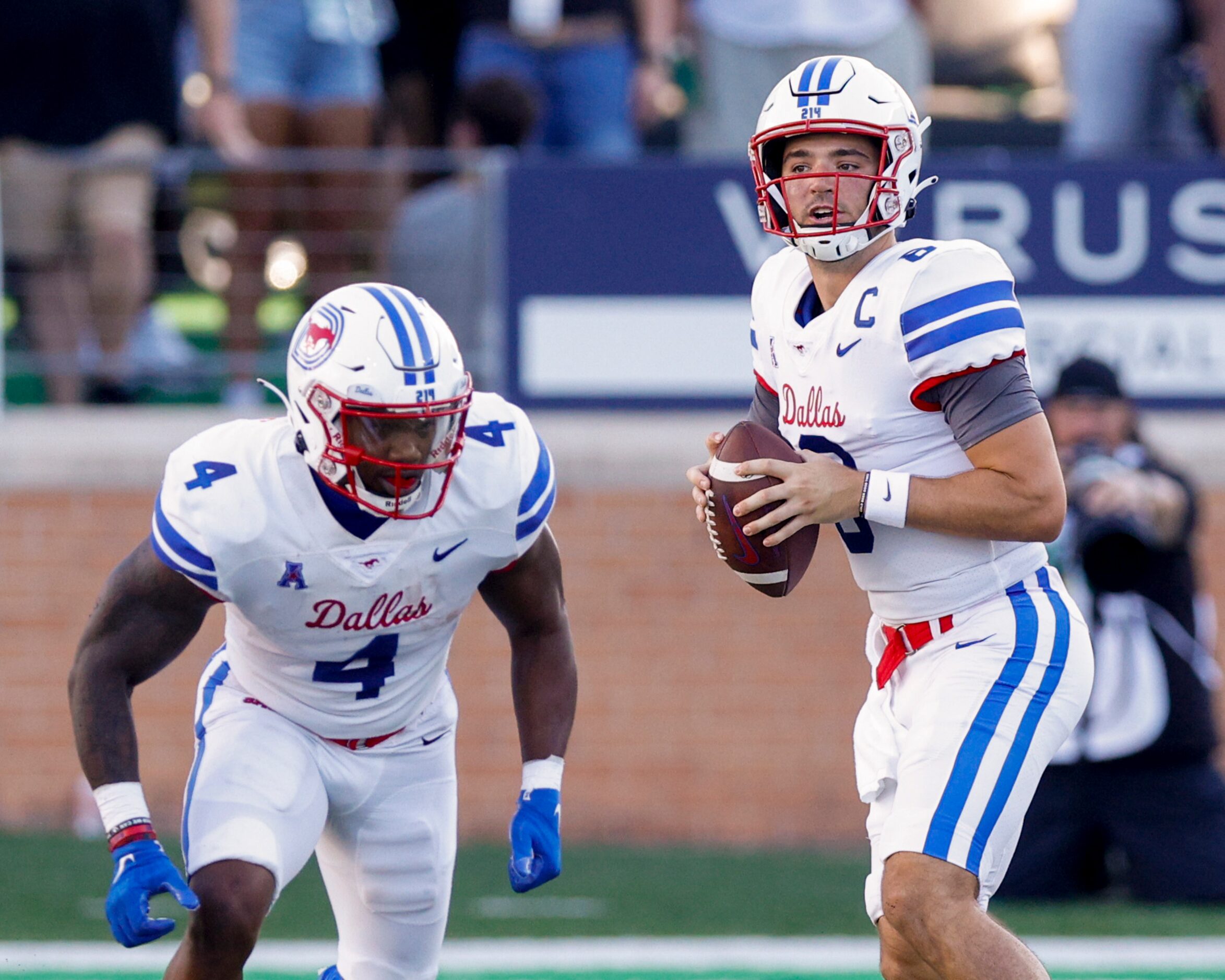 SMU quarterback Tanner Mordecai (8) looks to pass the ball alongside running back Tre...