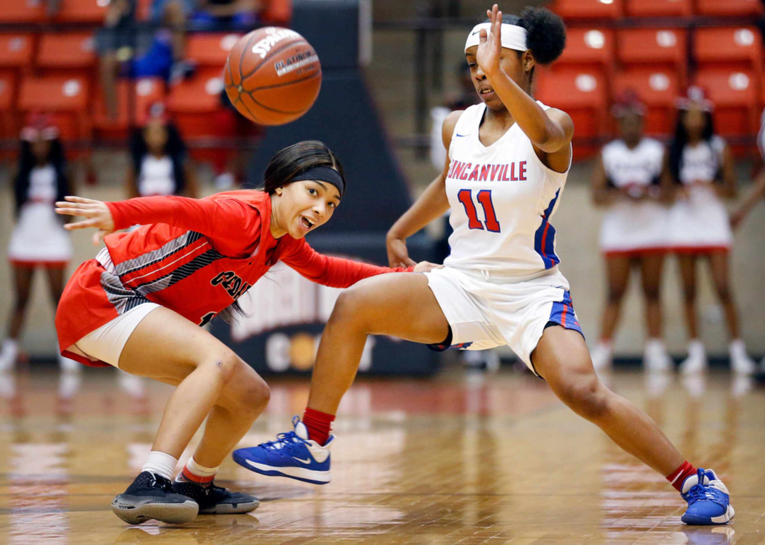 Duncanville's Tristen Taylor (11) swats the ball away from Cedar Hills' Iyonia Smith (5)...
