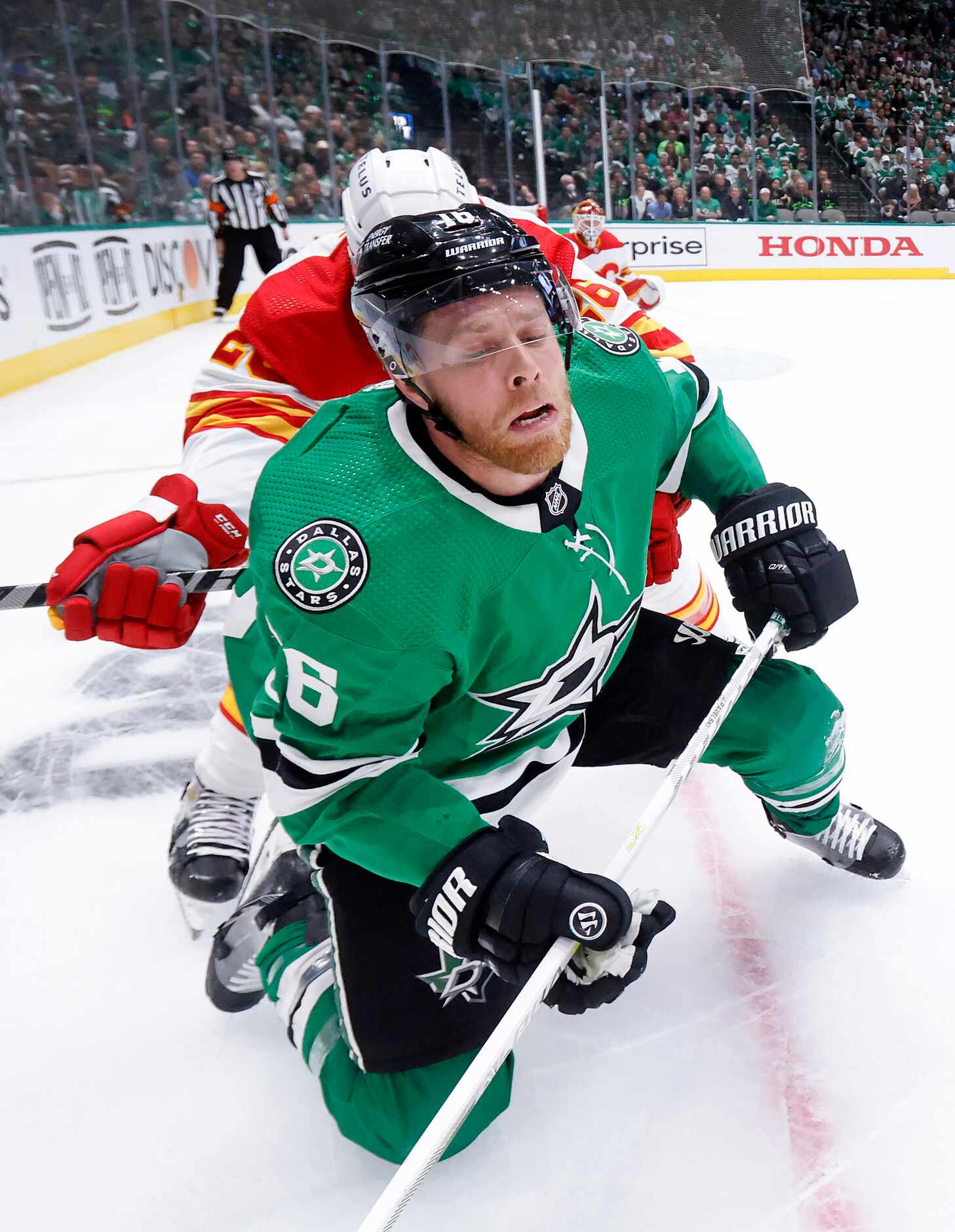 Dallas Stars center Joe Pavelski (16) is checked to the ice by Calgary Flames defenseman...