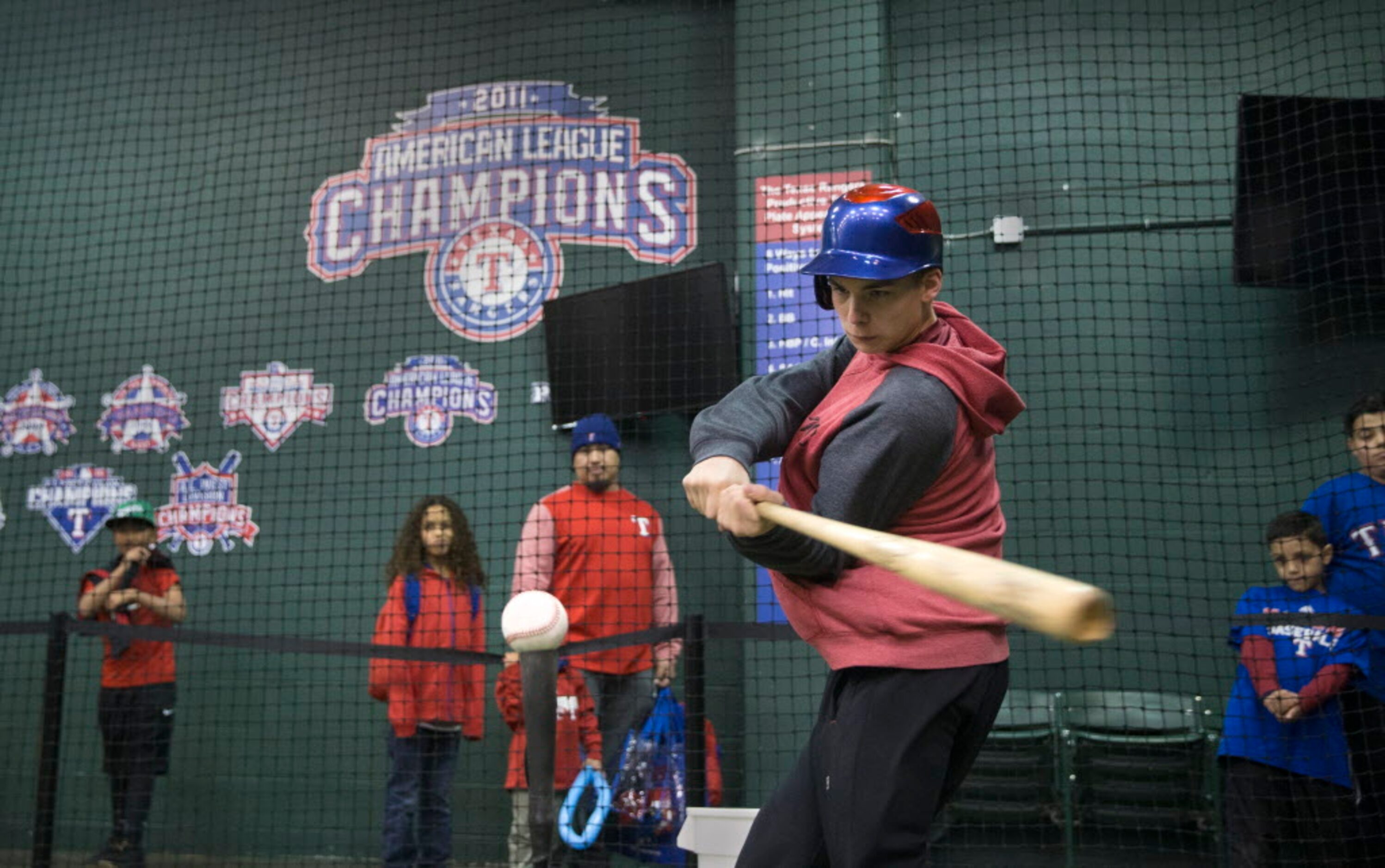 Brendan Robinson, 13, of Boswell, Oklahoma bats during Texas Rangers Fan Fest at Globe Life...