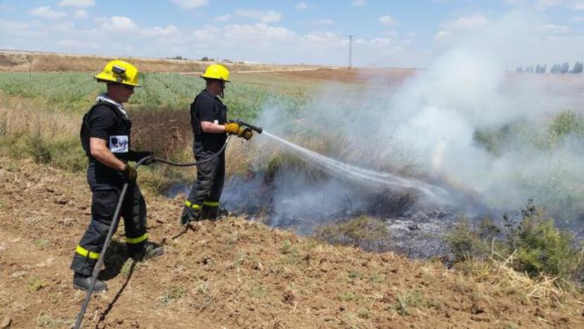 
Mesquite firefighter Joe Baker and captain Jeffrey Miller fight a a brush fire in Sderot,...