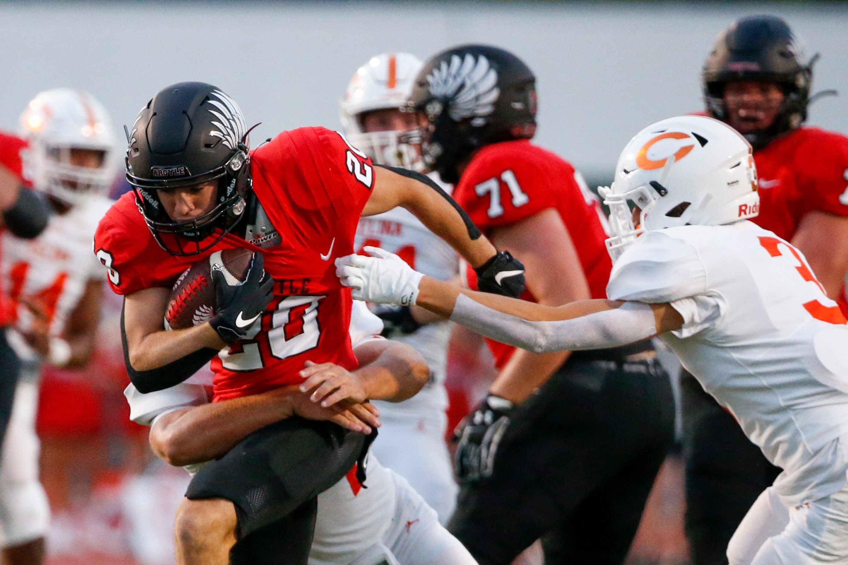 Argyle running back Landon Farris (20) is tackled by Celina linebacker Zach Veverka (34) as...