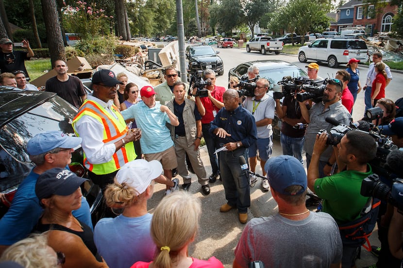 Houston Mayor Sylvester Turner talked with residents on a street of homes damaged by...