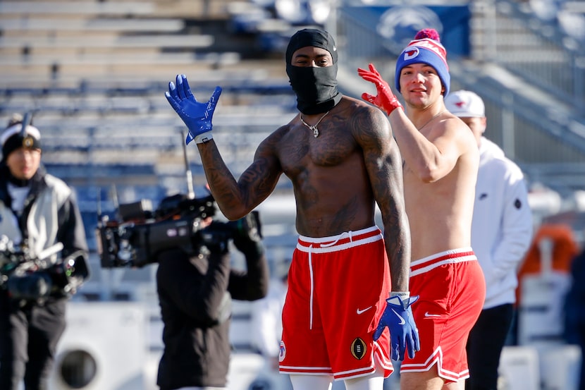 SMU players warm up shirtless before a game against Penn State in the first round of the...