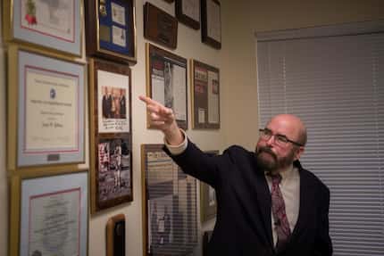 Joseph Gutheinz, an attorney known as the "Moon Rock Hunter," points to plaques in his...