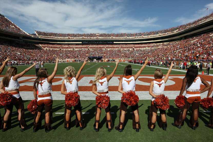Members of the University of Texas pom squad cheer on the Texas Longhorns against the Texas...