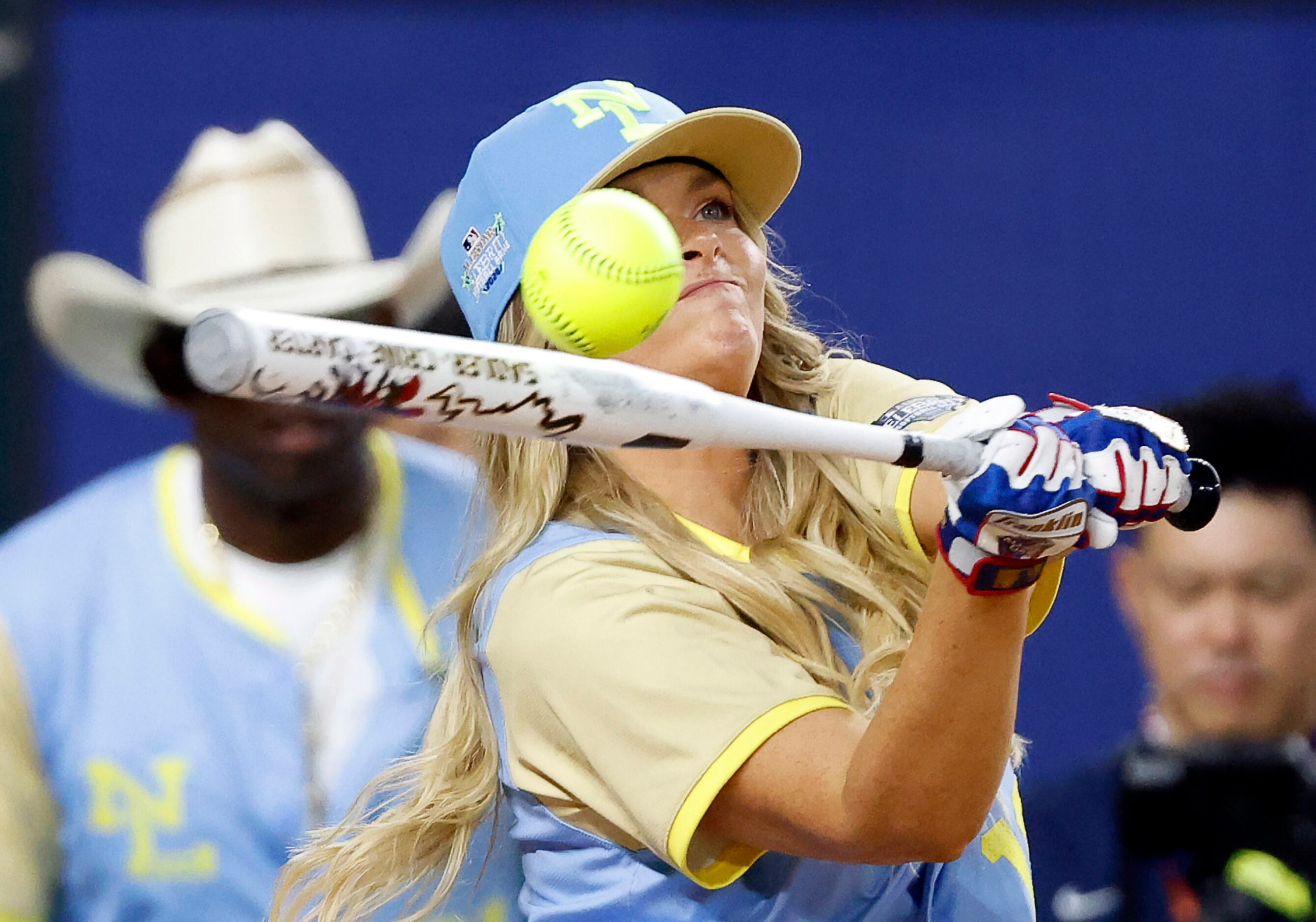 National League’s Camille Kostek makes contact with the ball as she hits during the first...