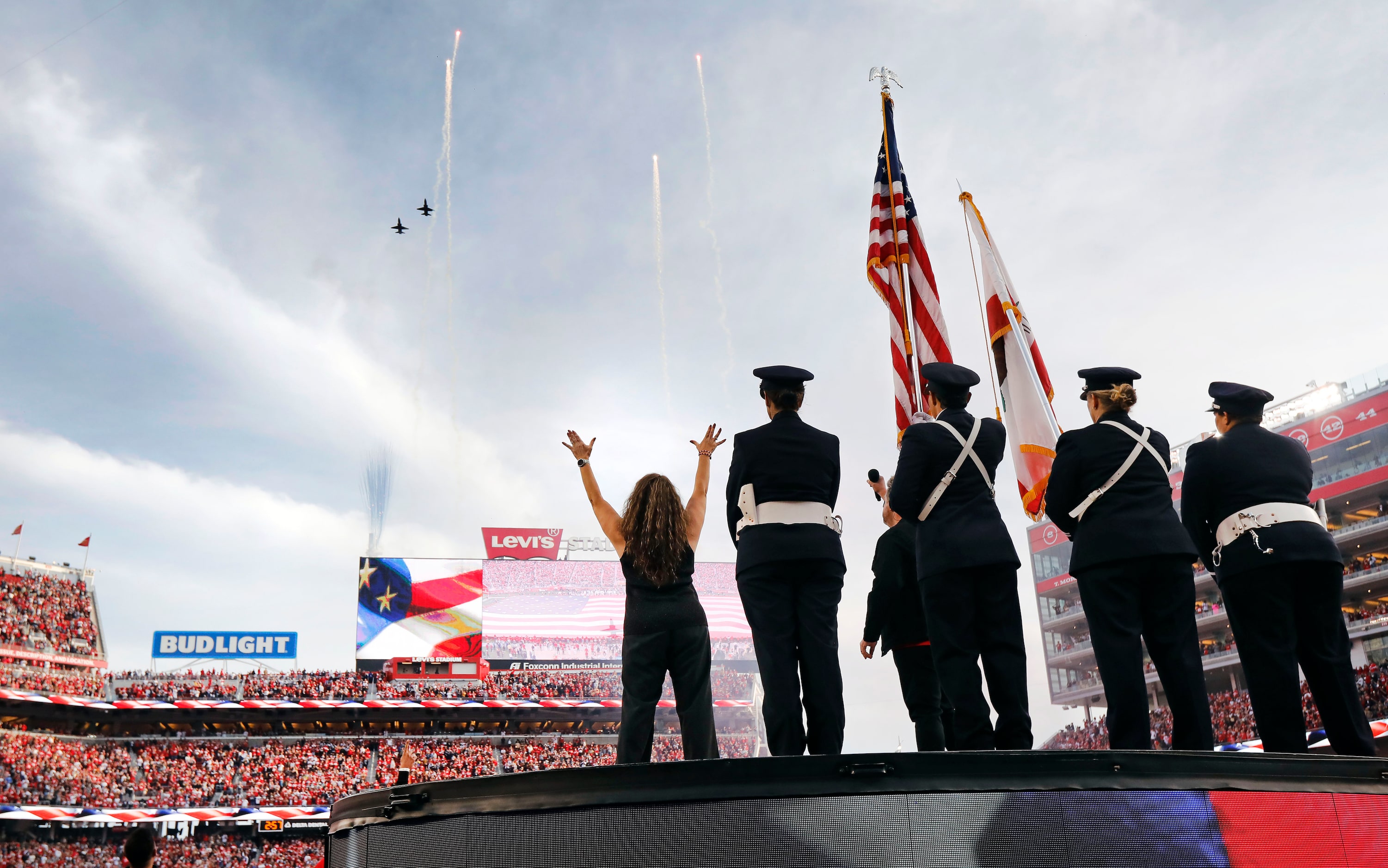 A pair of T-38 military aircraft fly over Levi's Stadium at try end of the national anthem...