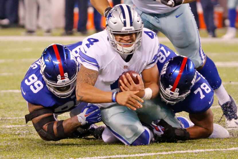 Dallas Cowboys quarterback Dak Prescott (4) is sacked by New York Giants nose tackle Robert...
