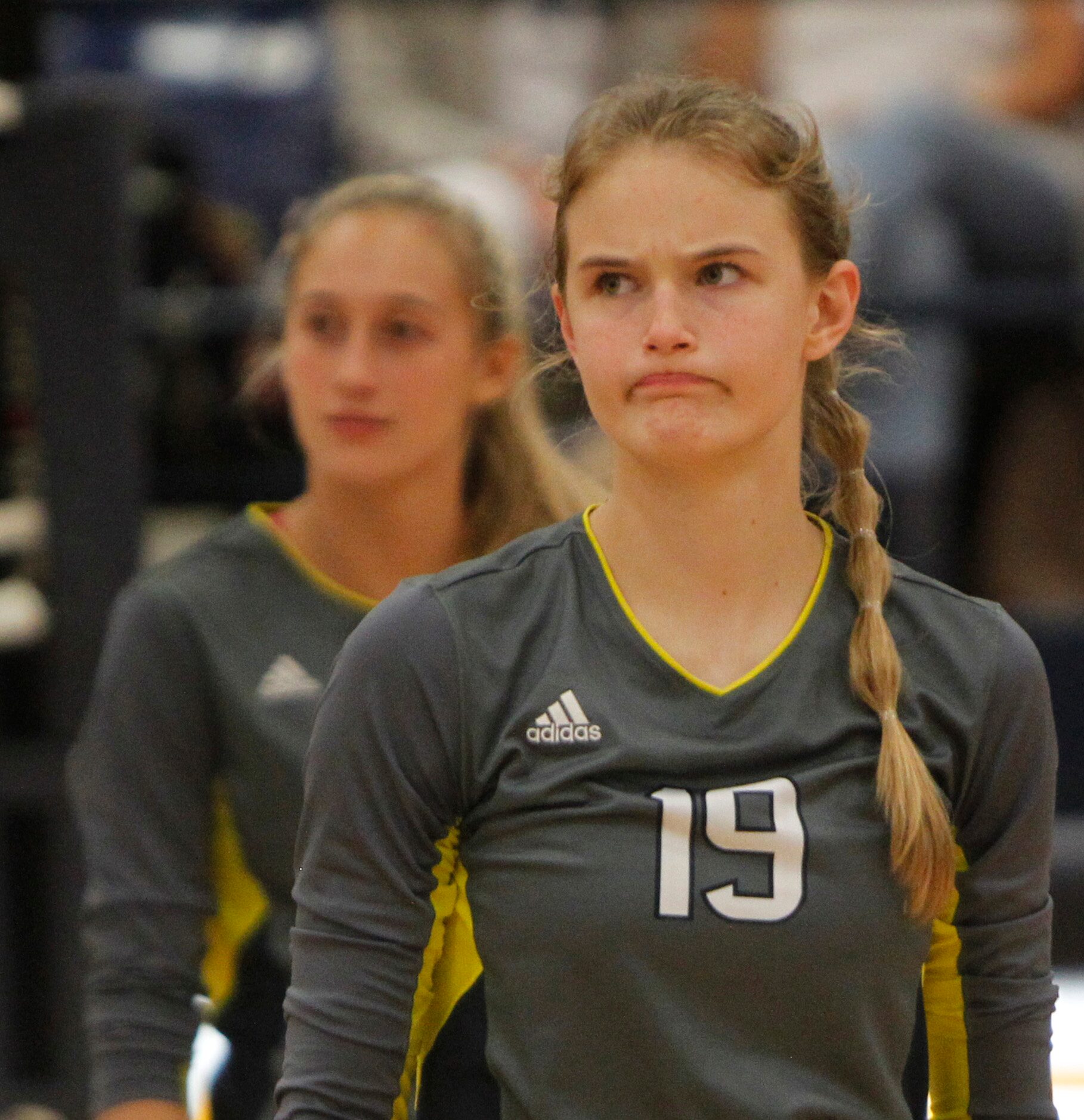 Highland Park outside hitter Emily Hellmuth (19) reacts as a game official awarded a point...