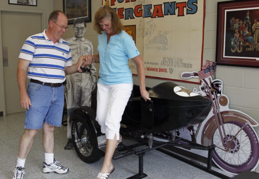 Kevin Mixon helps his wife Donna Gail Mixon, of Walterboro, S.C., from a sidecar in the Andy...