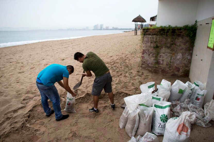 Men prepare for the arrival  of Hurricane Patricia — the strongest hurricane ever recorded...