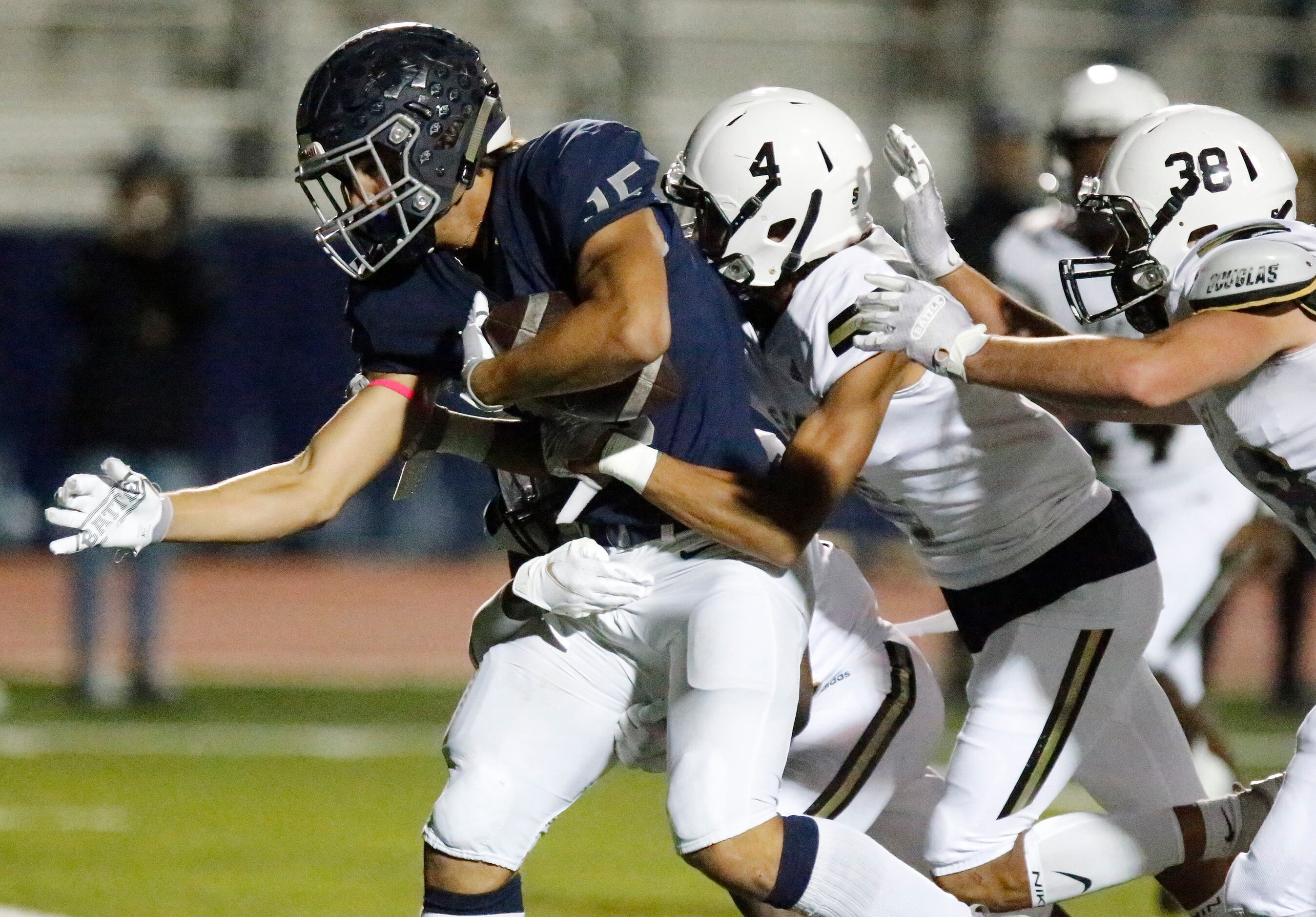 Flower Mound High School wide receiver Walker Mulkey (15) is brought down by Plano East High...