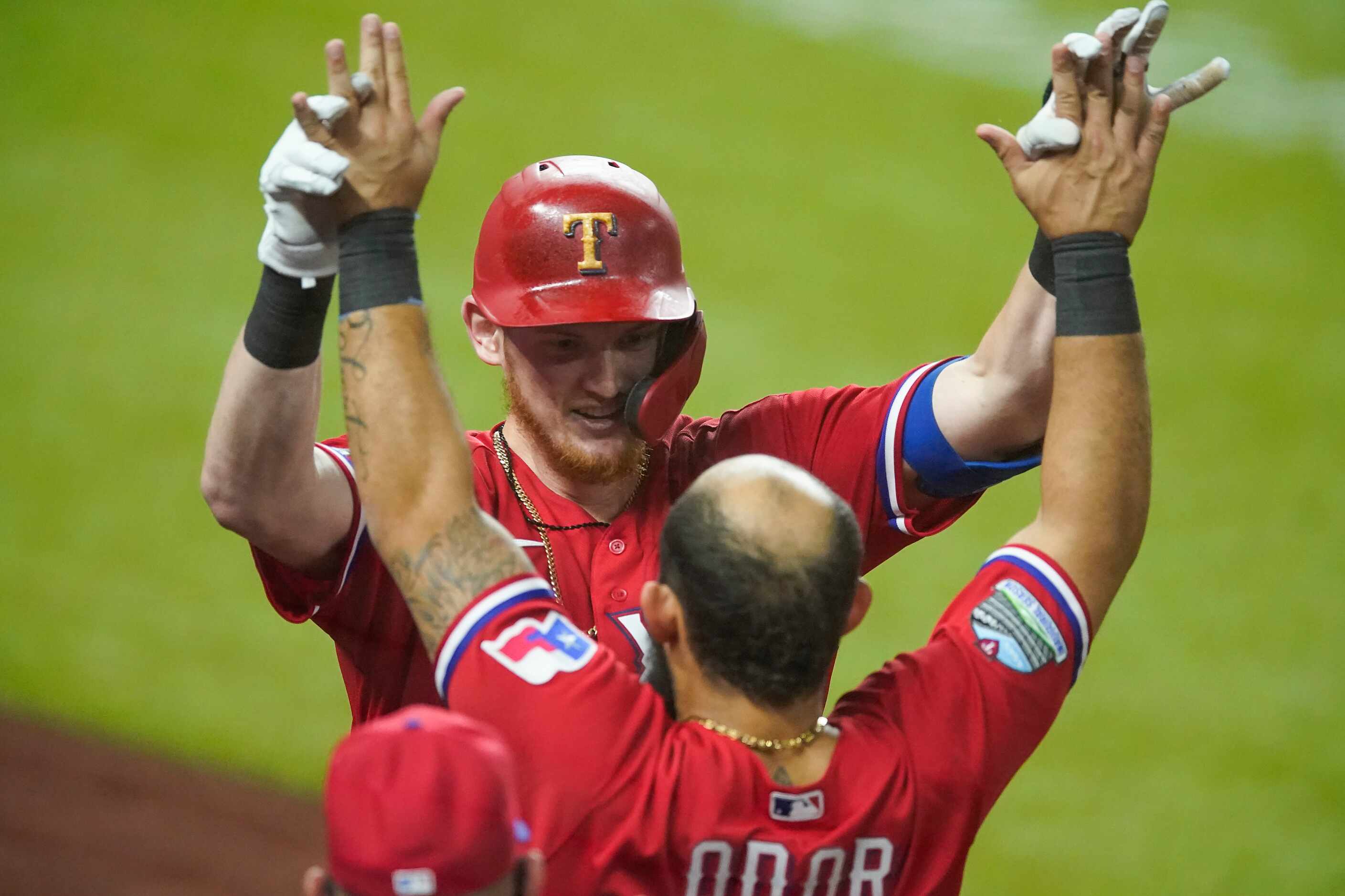 Texas Rangers catcher Sam Huff celebrates with Texas Rangers second baseman Rougned Odor...