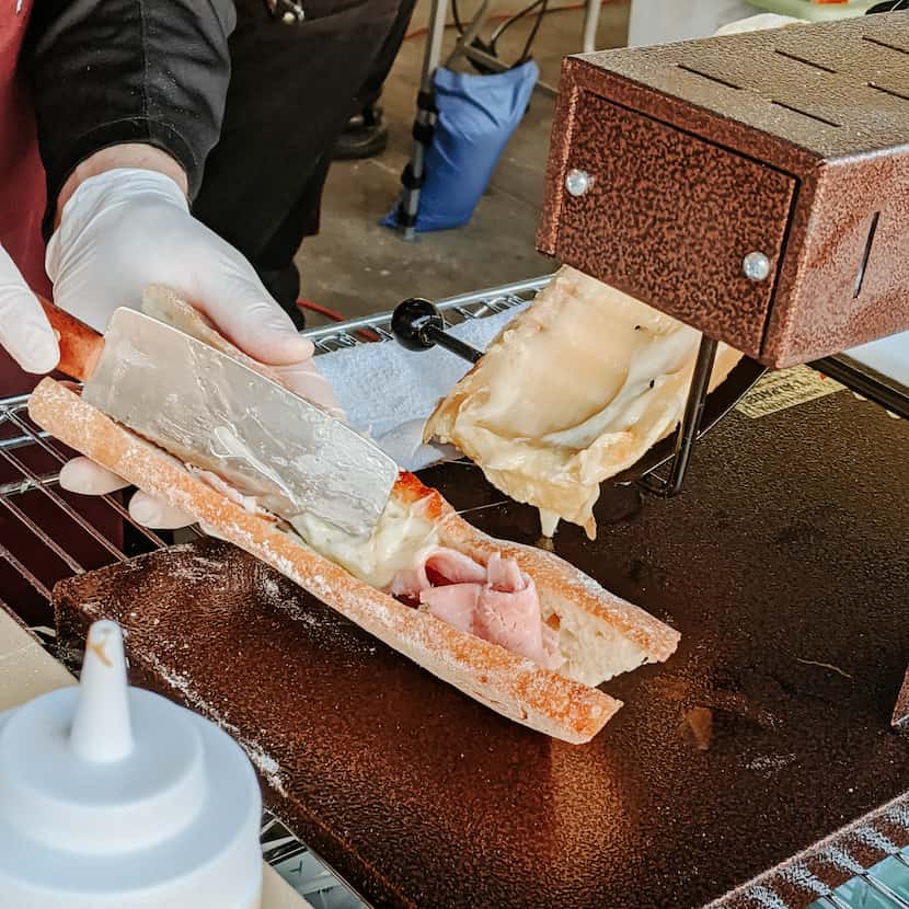 Rich Rogers of Scardello Artisan Cheese makes raclette sandwiches at the Dallas Farmers Market.