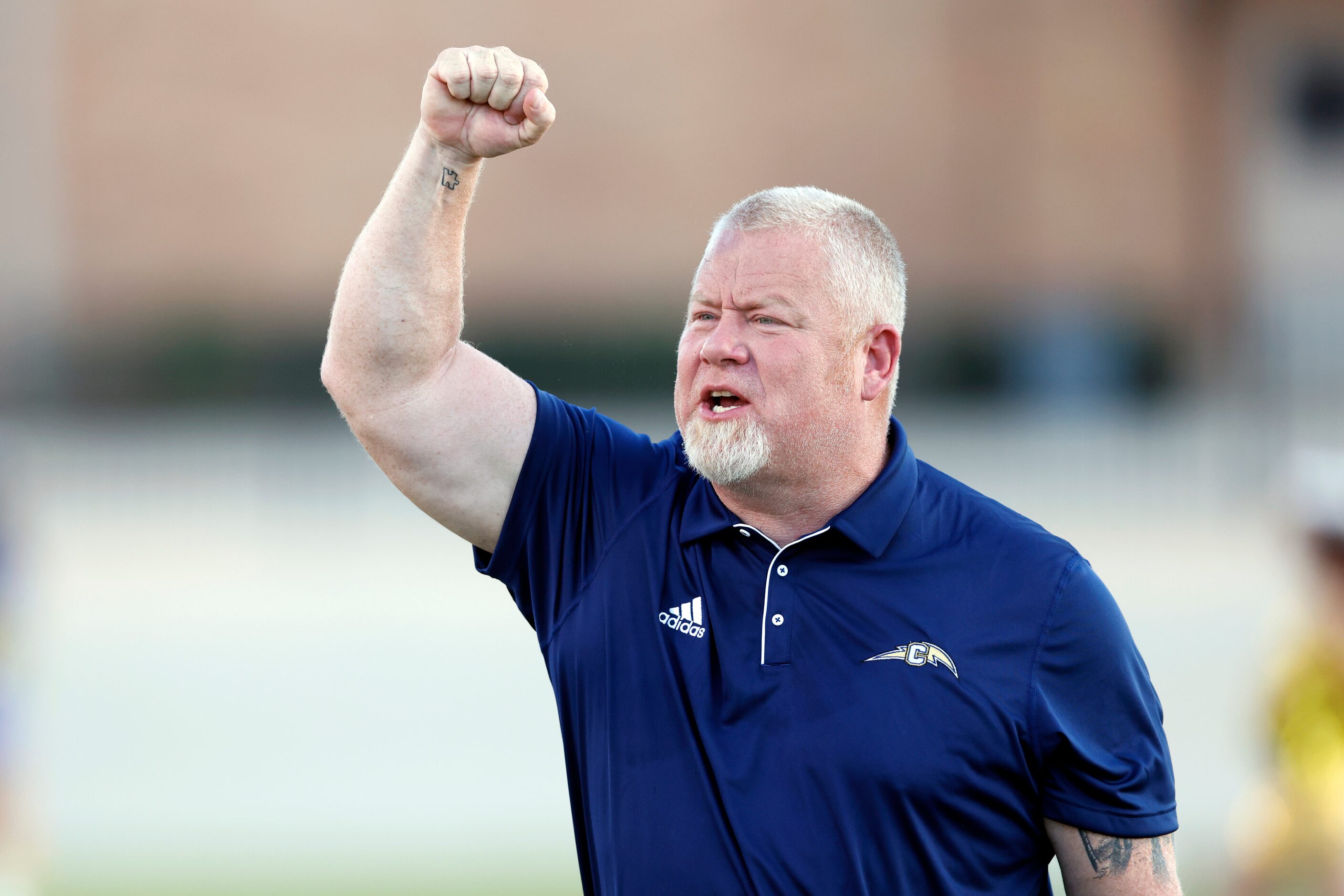 Conrad head coach Josh Ragsdale pumps up his team on the sideline before the first half of a...