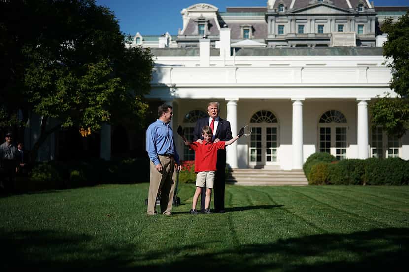 11-year-old Frank "FX" Giaccio talks with U.S. President Donald Trump while mowing the grass...