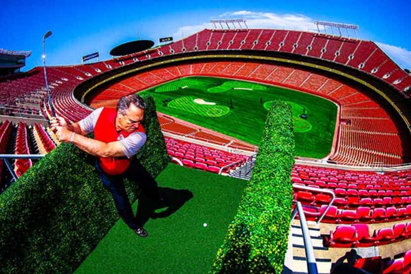 A golfer tees off inside Arrowhead Stadium in Kansas City, Mo., which was transformed into a...