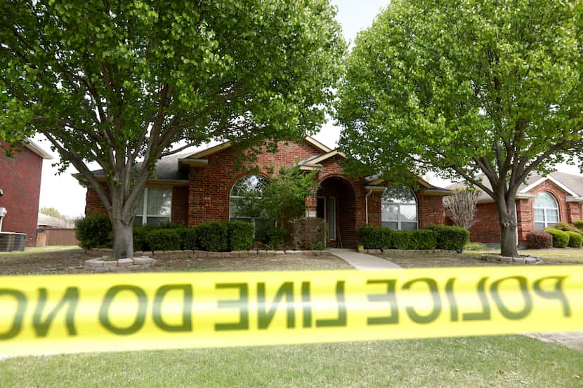 Police tape surrounded the family's home Monday.
