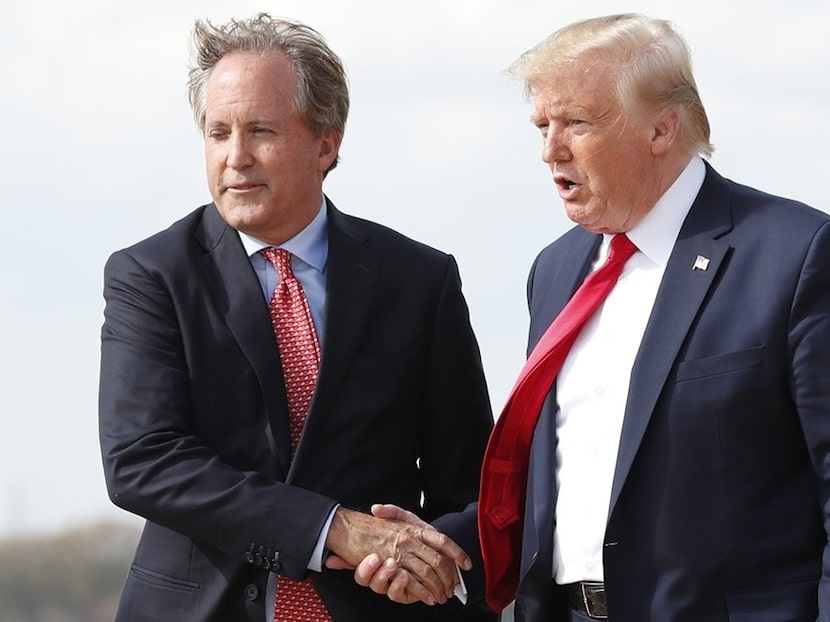 Donald Trump greets Texas Attorney General Ken Paxton as Lt. Governor Dan Patrick follows at...