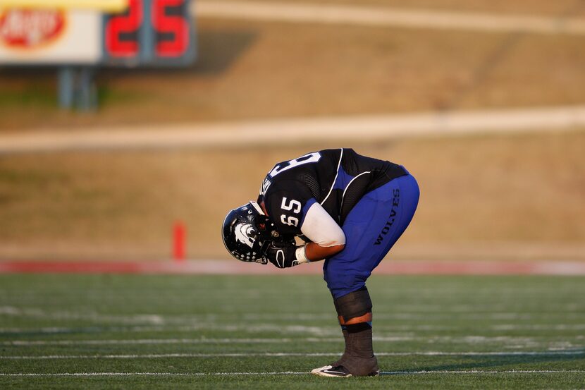 Plano West's Pirouz Kamalipour (65) reacts to an interception in the final seconds of the...