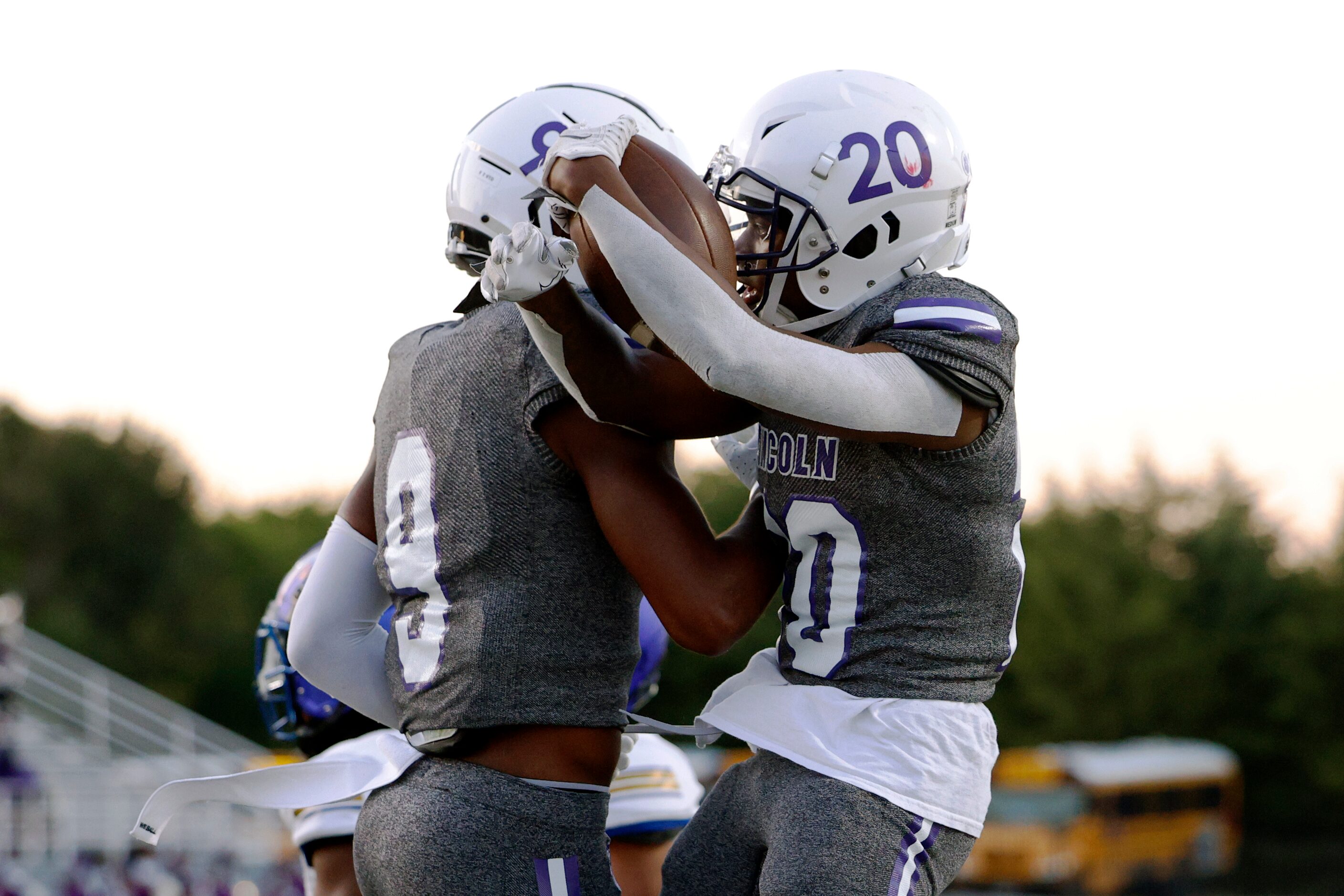 Lincoln running back Jaimirian Robertson (20) celebrates his touchdown with wide receiver...