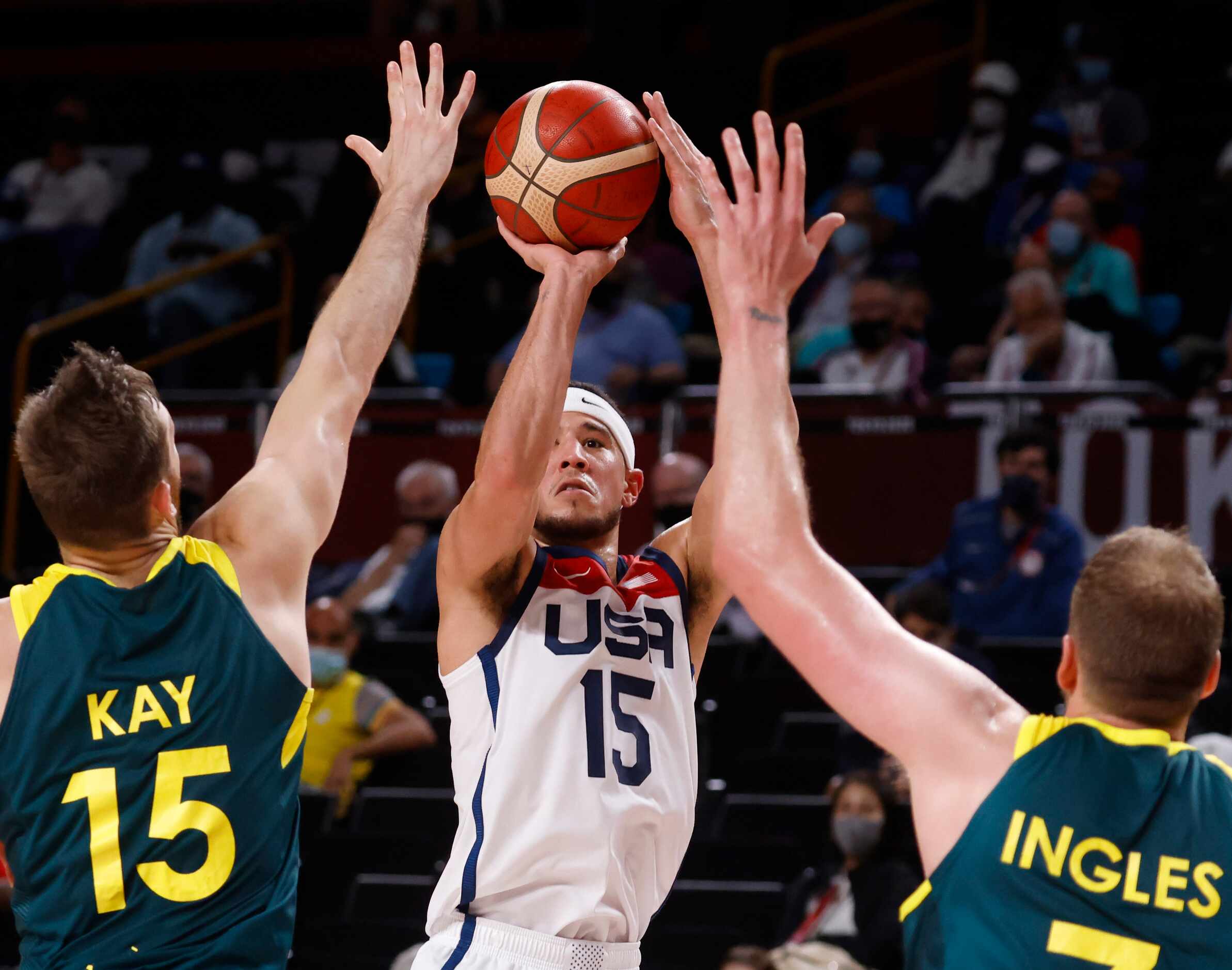 USA’s Devin Booker (15) shoots in front of Australia’s  Nic Kay (15) and Joe Ingles (7)...