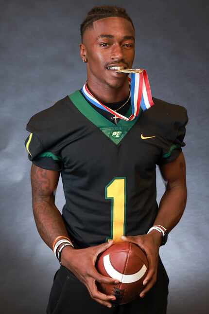 DeSoto High School wide receiver Johntay Cook II holds a football during a photoshoot at...