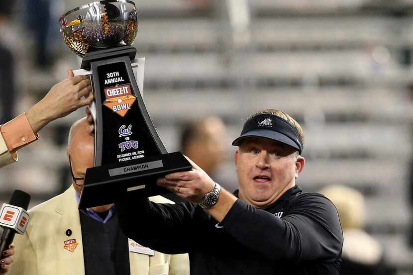 TCU coach Gary Patterson holds up the trophy after the team's Cheez-It Bowl NCAA college...