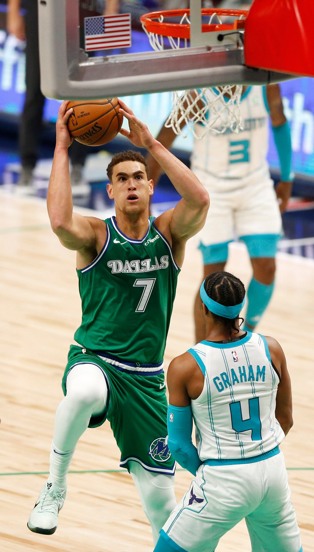 Dallas Mavericks center Dwight Powell (7) makes his way to the basket as he is defended by...