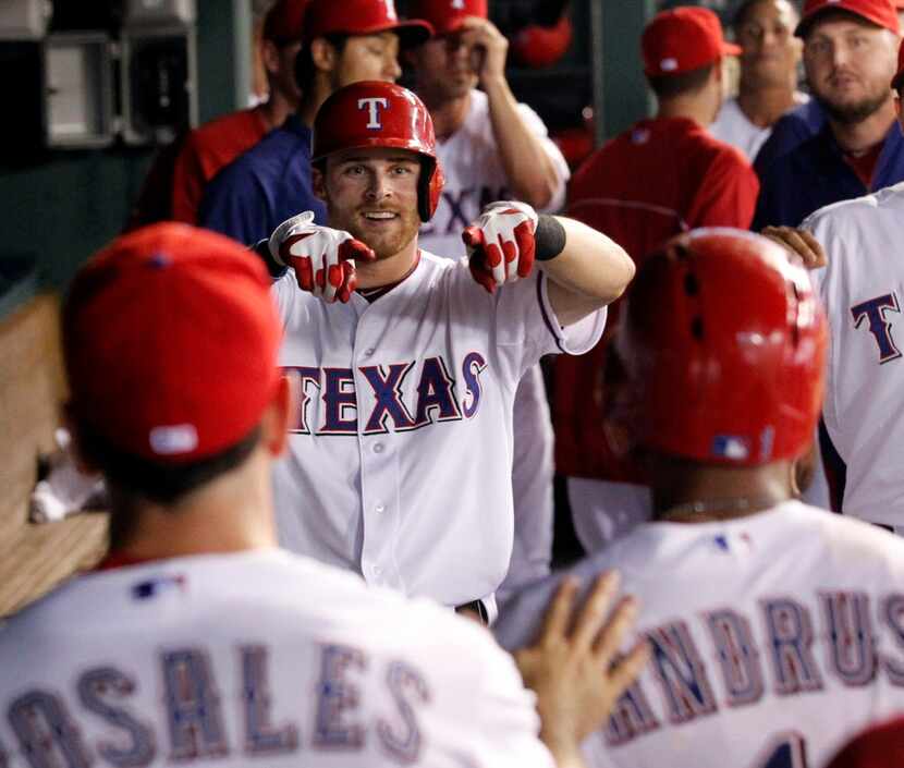 Texas Rangers left fielder Craig Gentry (23) points to Texas Rangers shortstop Elvis Andrus...