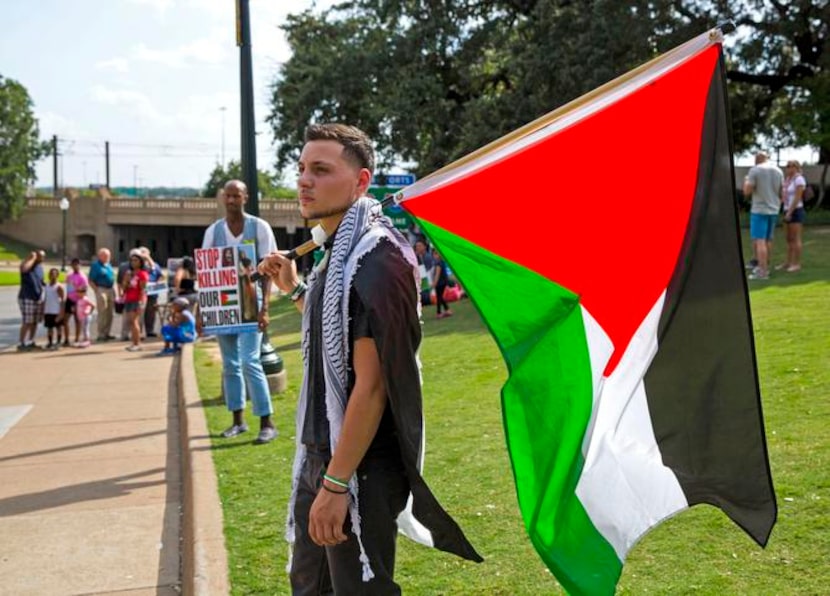 
Mahir Hassan of Arlington  brought the Palestinian flag to a rally at Dealey Plaza in on...