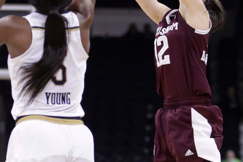 Texas A&M guard Danni Williams (12) shoots over Notre Dame guard Jackie Young (5) during the...