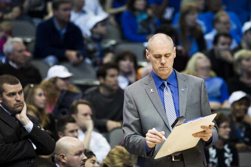 Dallas Mavericks head coach Rick Carlisle draws up a play during the second half of an NBA...