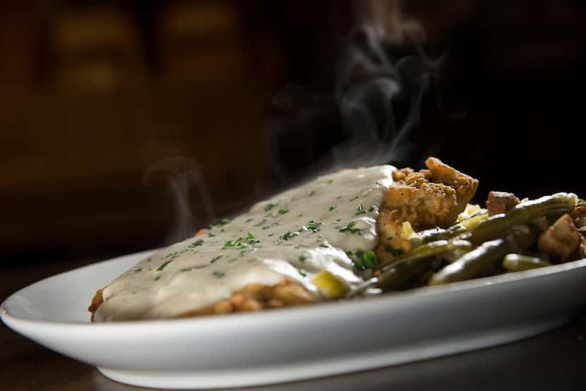 Smoked chicken-fried steak with mashed potatoes, braised green beans and gravy