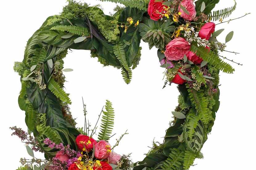
Moss, ferns and exotic plant leaves, field flowers, garden roses and succulents create a...