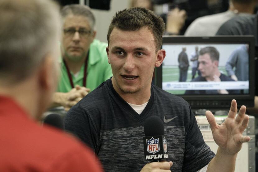 Texas A&M quarterback Johnny Manziel talks to members of the media during pro day for NFL...