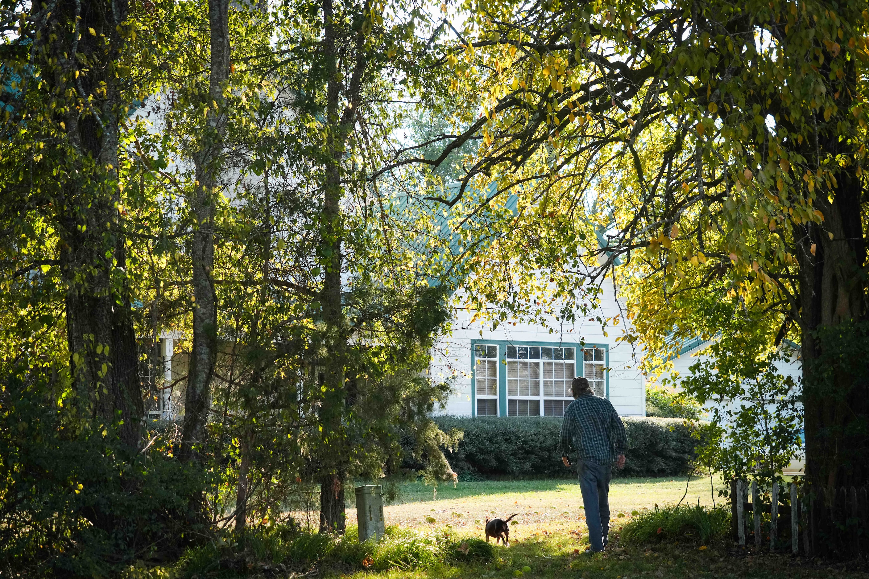 Dickie Dalby, 83, walks toward his home that was built near a log cabin built by his family...