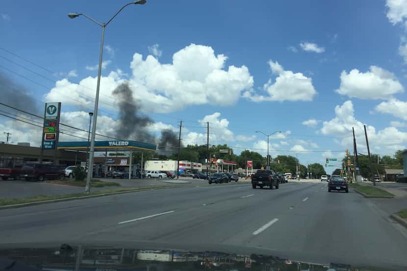 Smoke from a one-story house fire in northwest Dallas was seen from a nearby street Saturday.