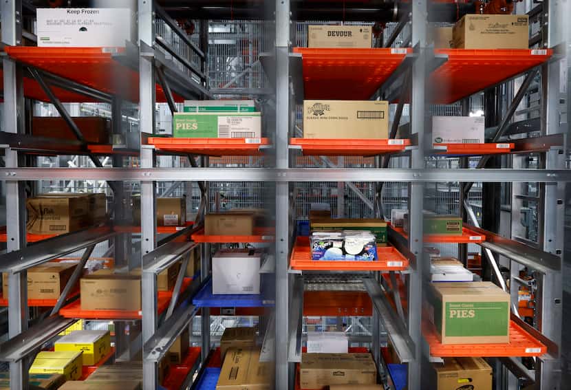 Cases of frozen goods stored on trays await robotic machines to pull and complete a store...