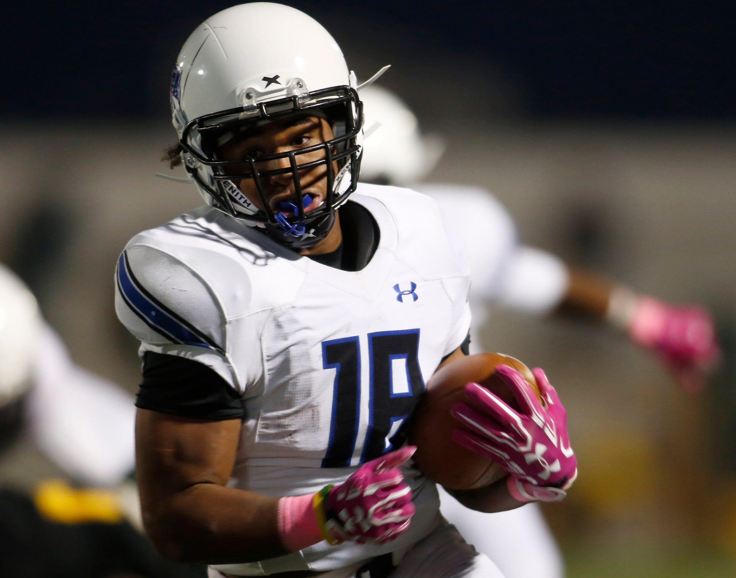 Trinity Christian running back Emari Matthews (18) rambles through the DeSoto secondary for...