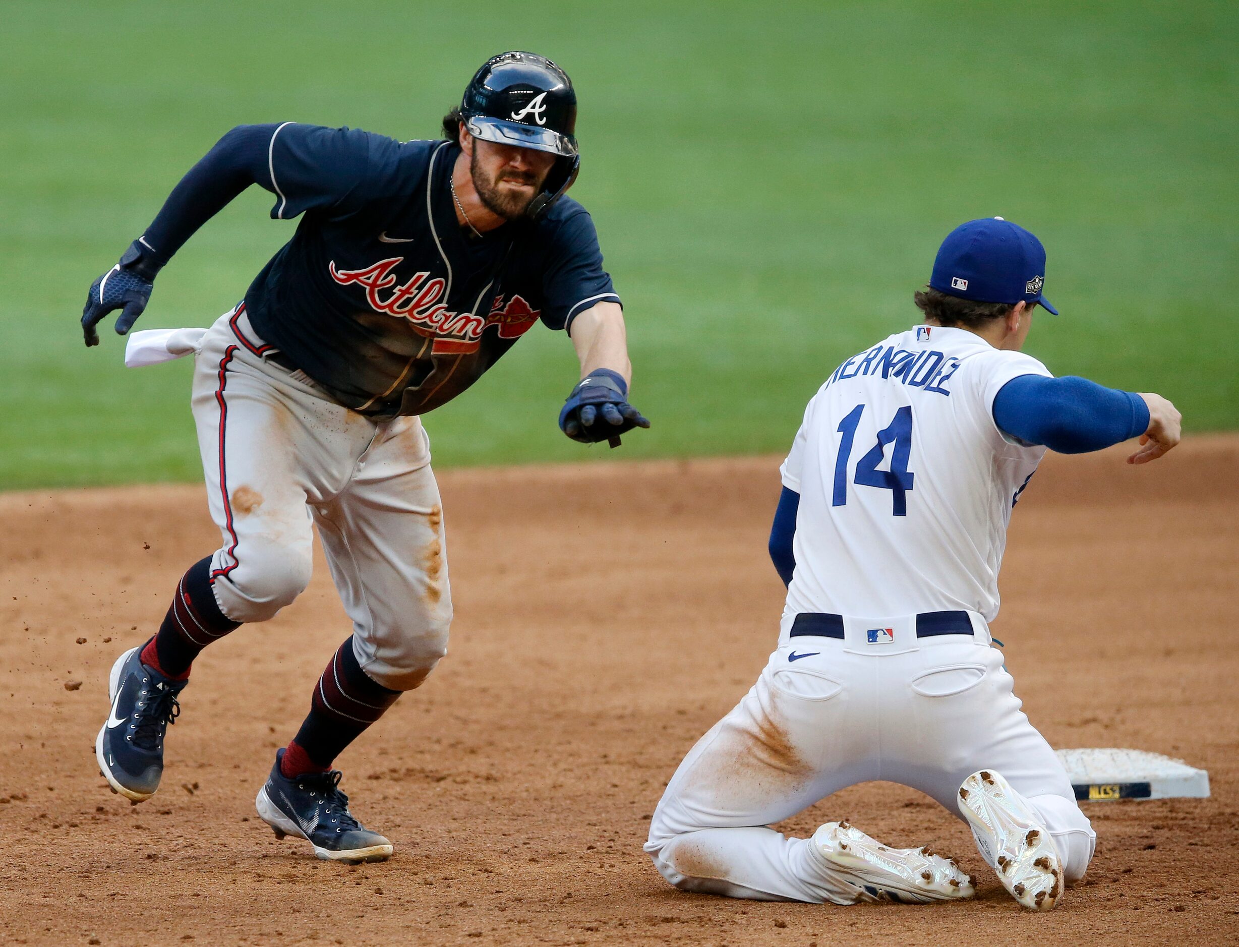 After Los Angeles Dodgers second baseman Enrique Hernandez (14) missed the ball thrown on a...