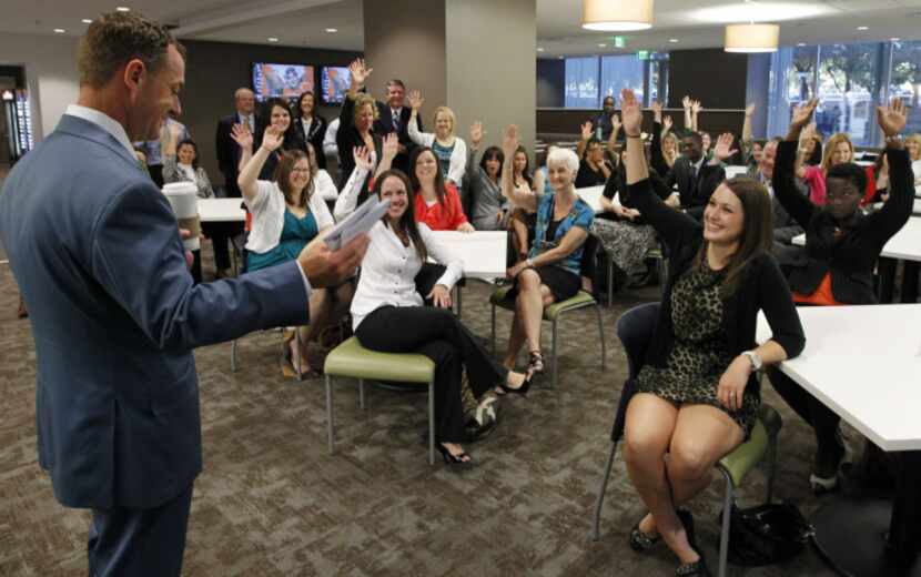 Tait Cruse, left, Managing Partner of Texas Financial names off birthdays and anniversaries...