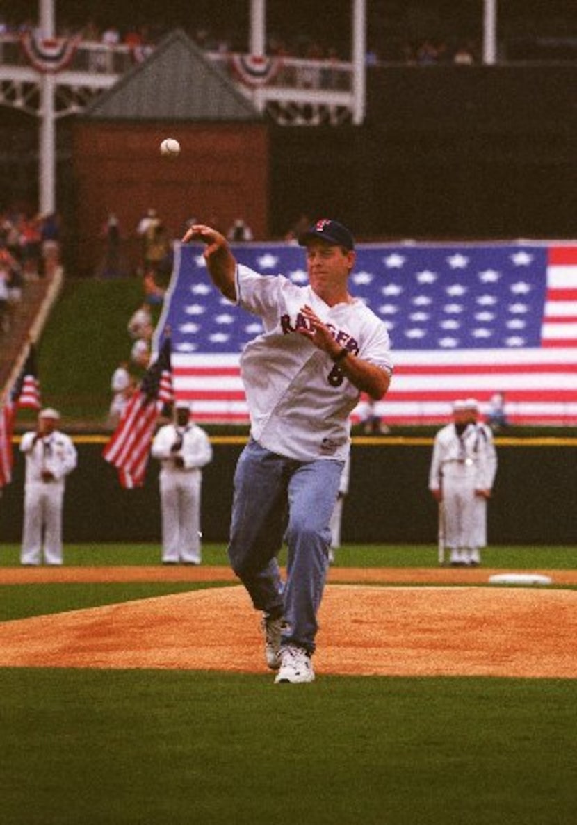 ORG XMIT: S0354615100_STAFF Troy Aikman throws out the first pitch of the Texas Rangers 2001...