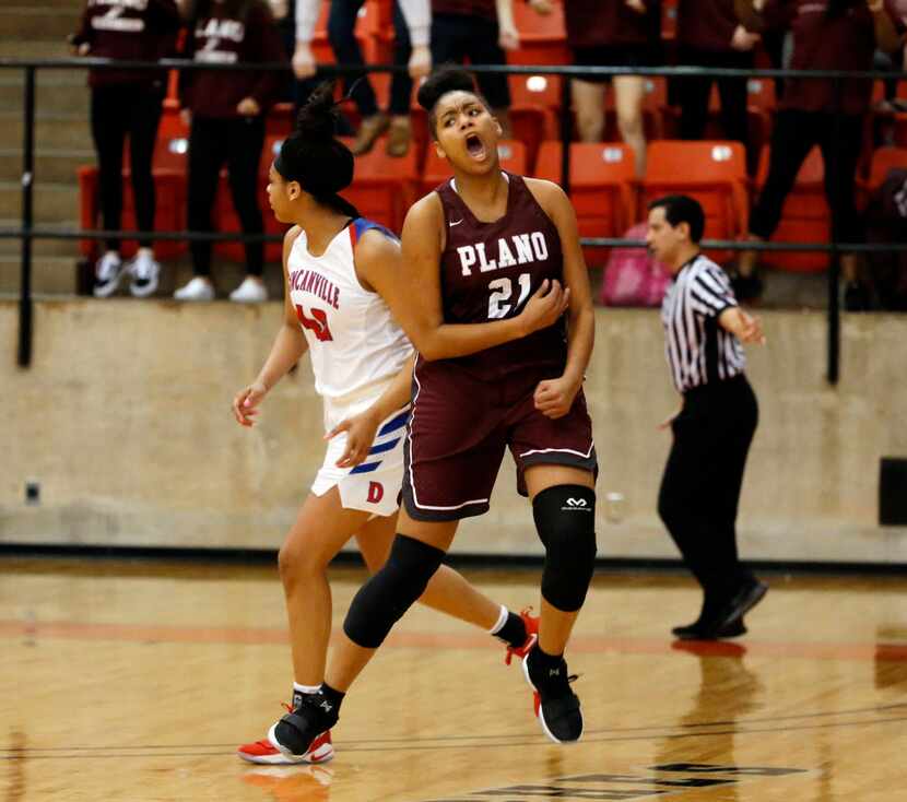 Plano's Lolo Davenport (21) celebrates a three-point basket that tied the game as...