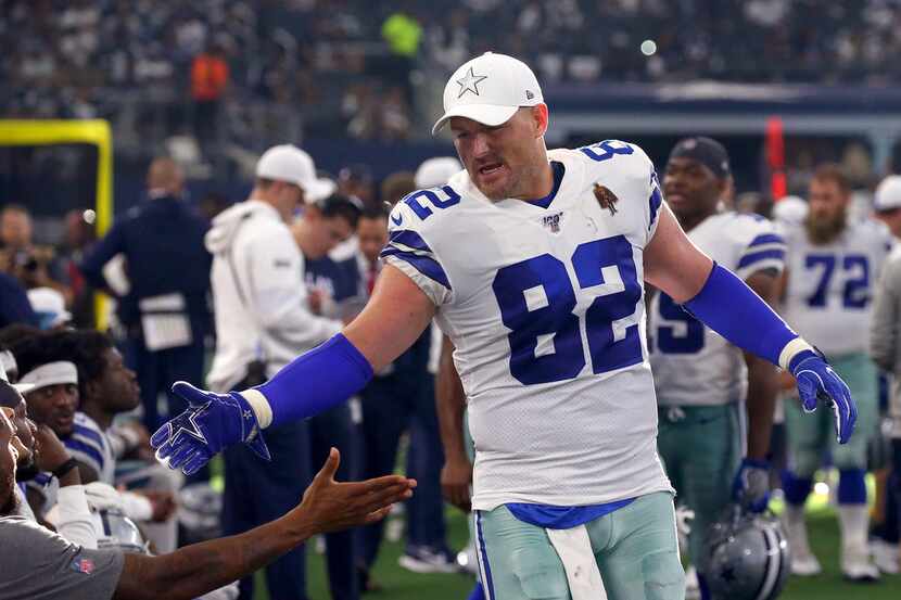 Jason Witten of the Dallas Cowboys celebrates on the sidelines in the fourth quarter against...