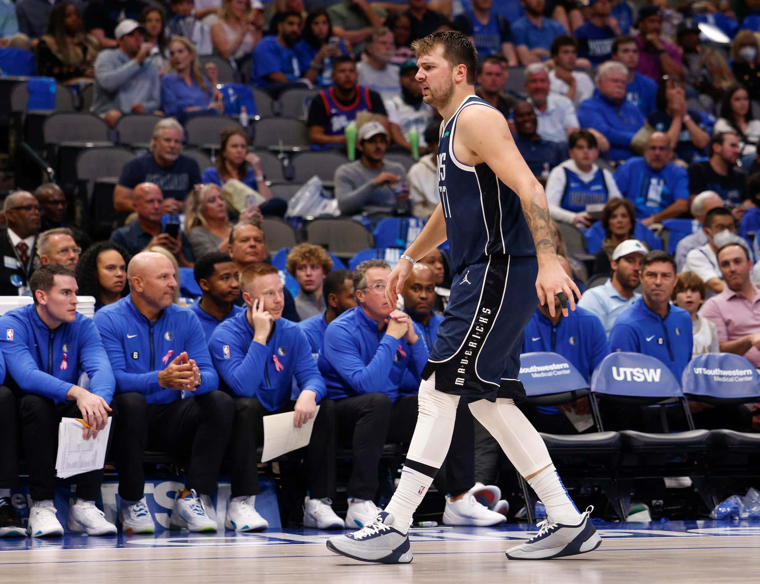 Dallas Mavericks guard Luka Doncic (77) limps down the court after appearing to injure his...